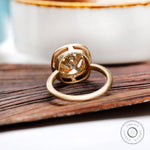 Back view of bezel set elongated cushion moissanite ring in yellow gold