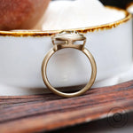 Minimal bezel solitaire moissanite ring showing smooth gold band