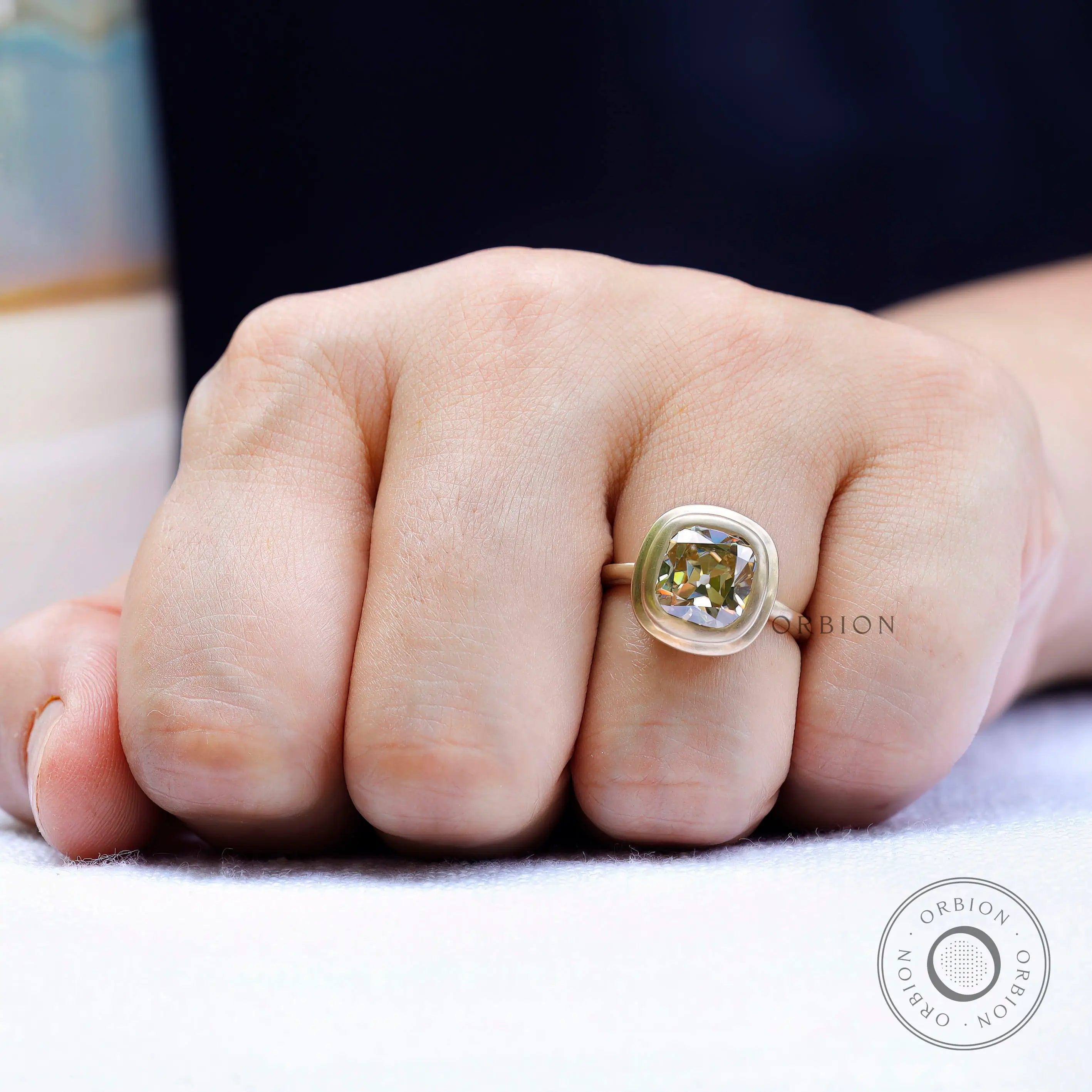 Minimalist yellow gold bezel set moissanite engagement ring