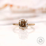 Front view of cushion champagne moissanite ring in matte finish yellow gold.