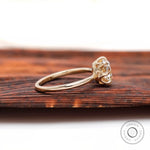 Side profile of elongated cushion moissanite ring in high polish yellow gold