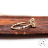 Side profile of elongated cushion moissanite ring in high polish yellow gold