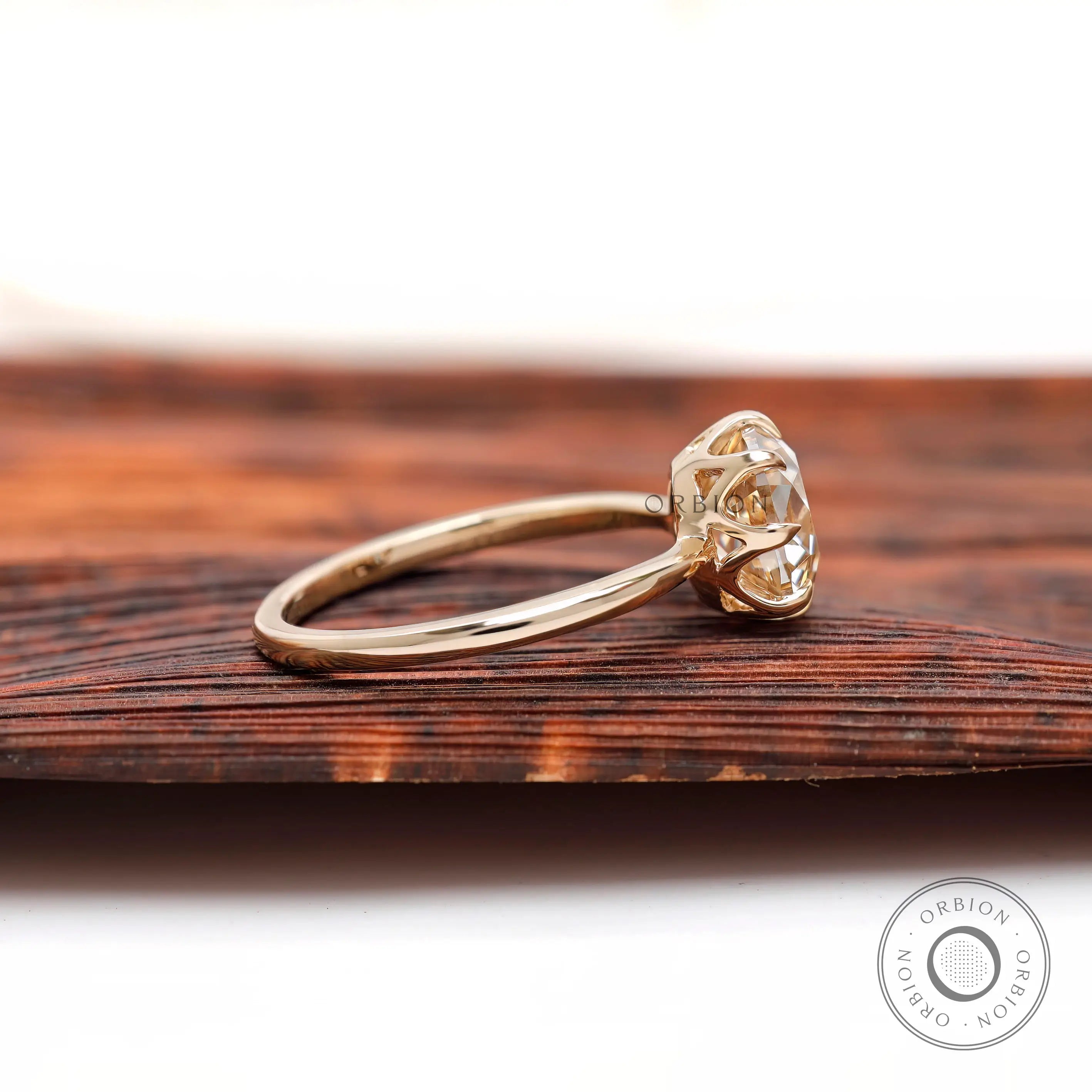 Side profile of elongated cushion moissanite ring in high polish yellow gold