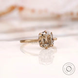 Angled side view of OMC cushion champagne moissanite solitaire ring.