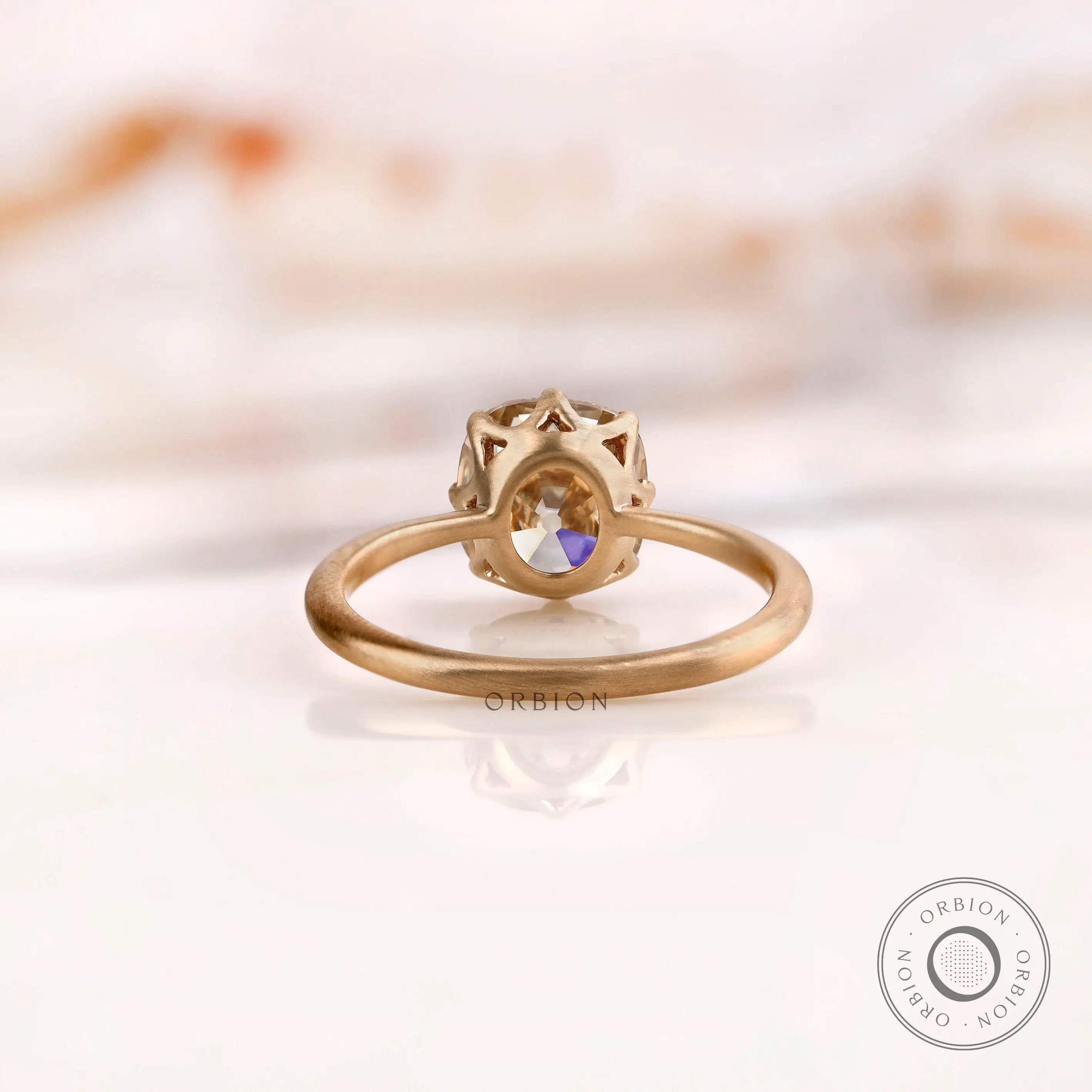 Back view of OMC cushion champagne moissanite solitaire ring.