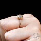 Hand wearing elongated cushion champagne moissanite engagement ring
