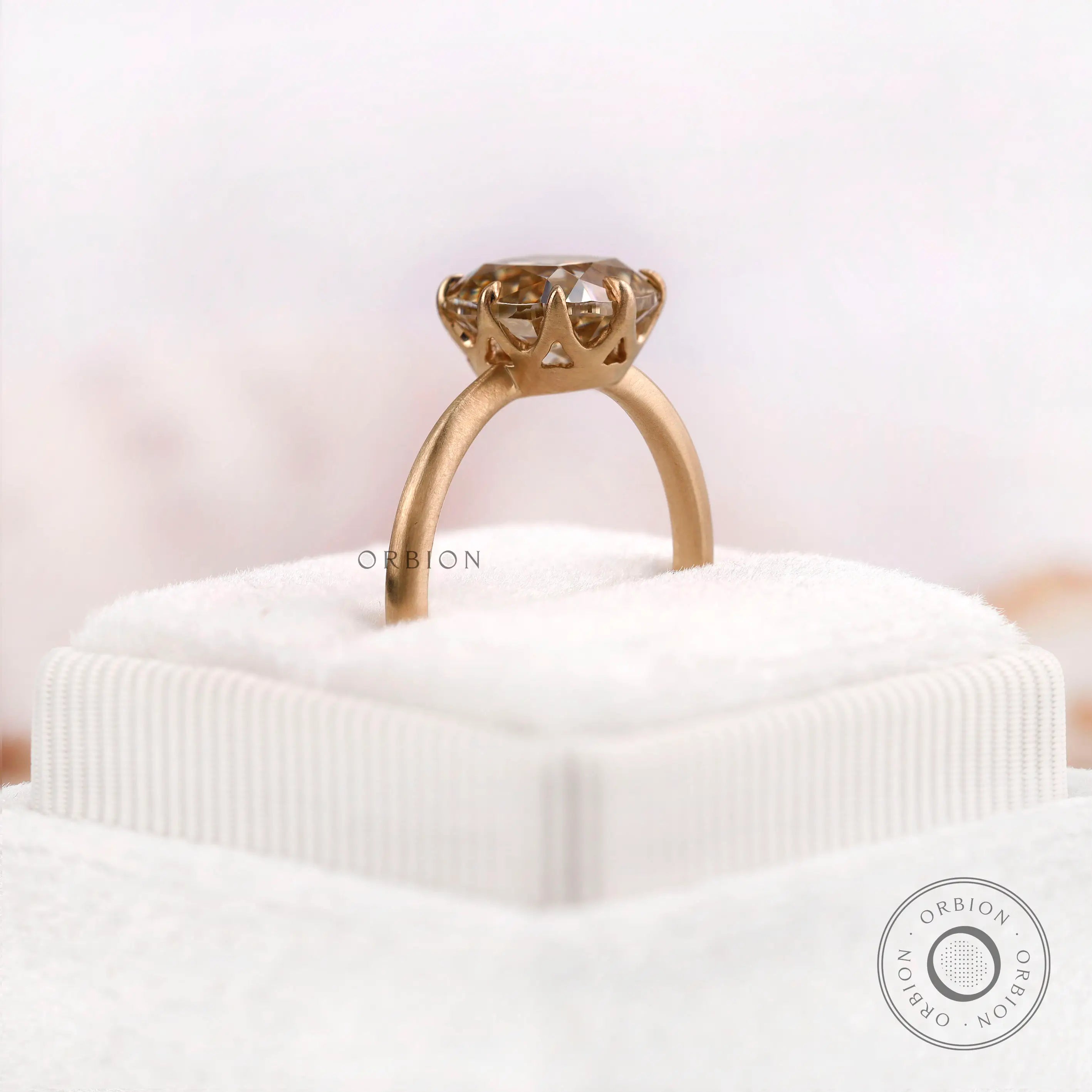 Top view of OMC cushion champagne moissanite solitaire ring in matte finish 