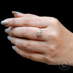 Classic solitaire ring with warm champagne tone moissanite on hand