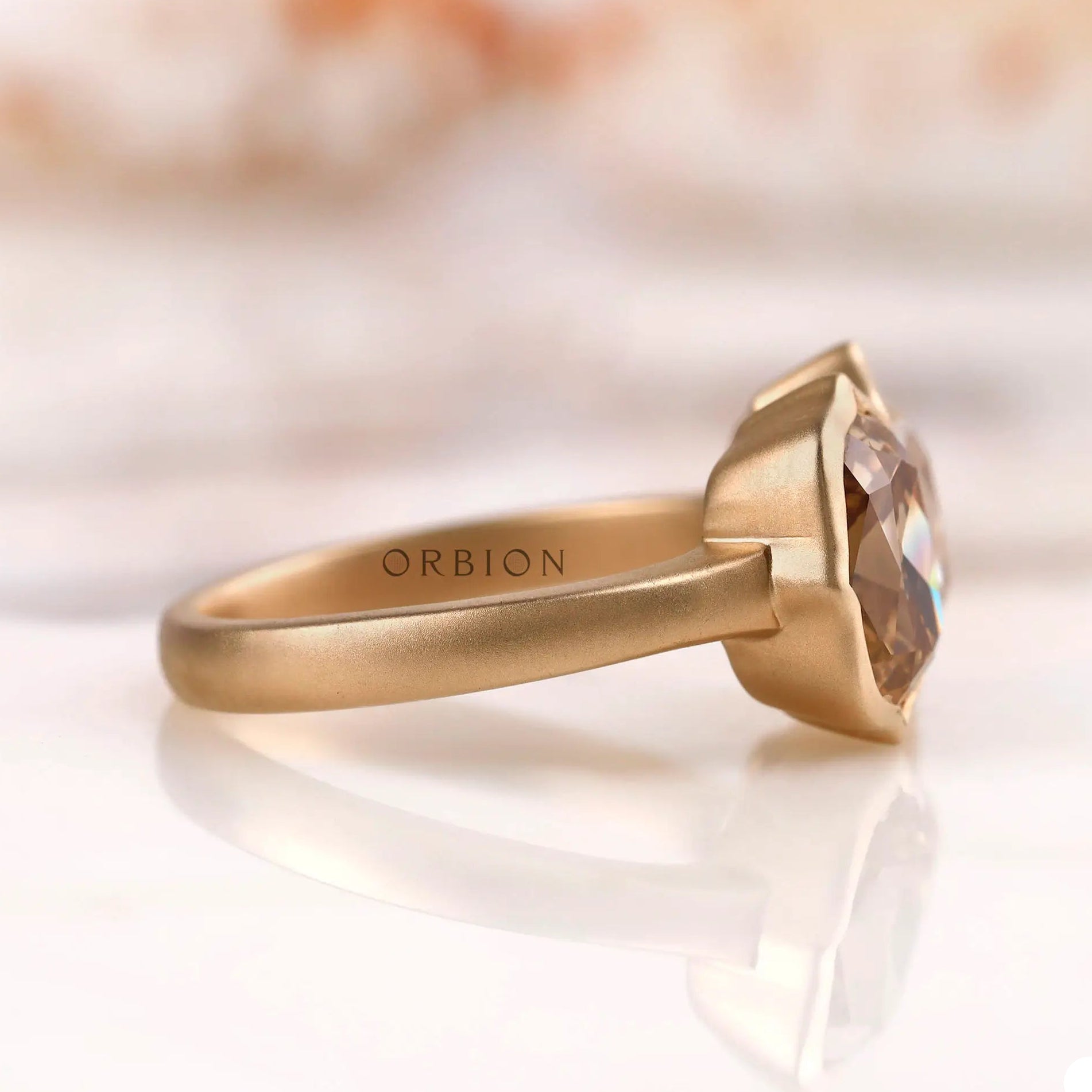 Two-stone elongated cushion moissanite ring in 10K yellow gold side view