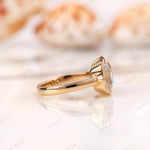 Side profile of bezel set double cushion moissanite ring in 10K yellow gold