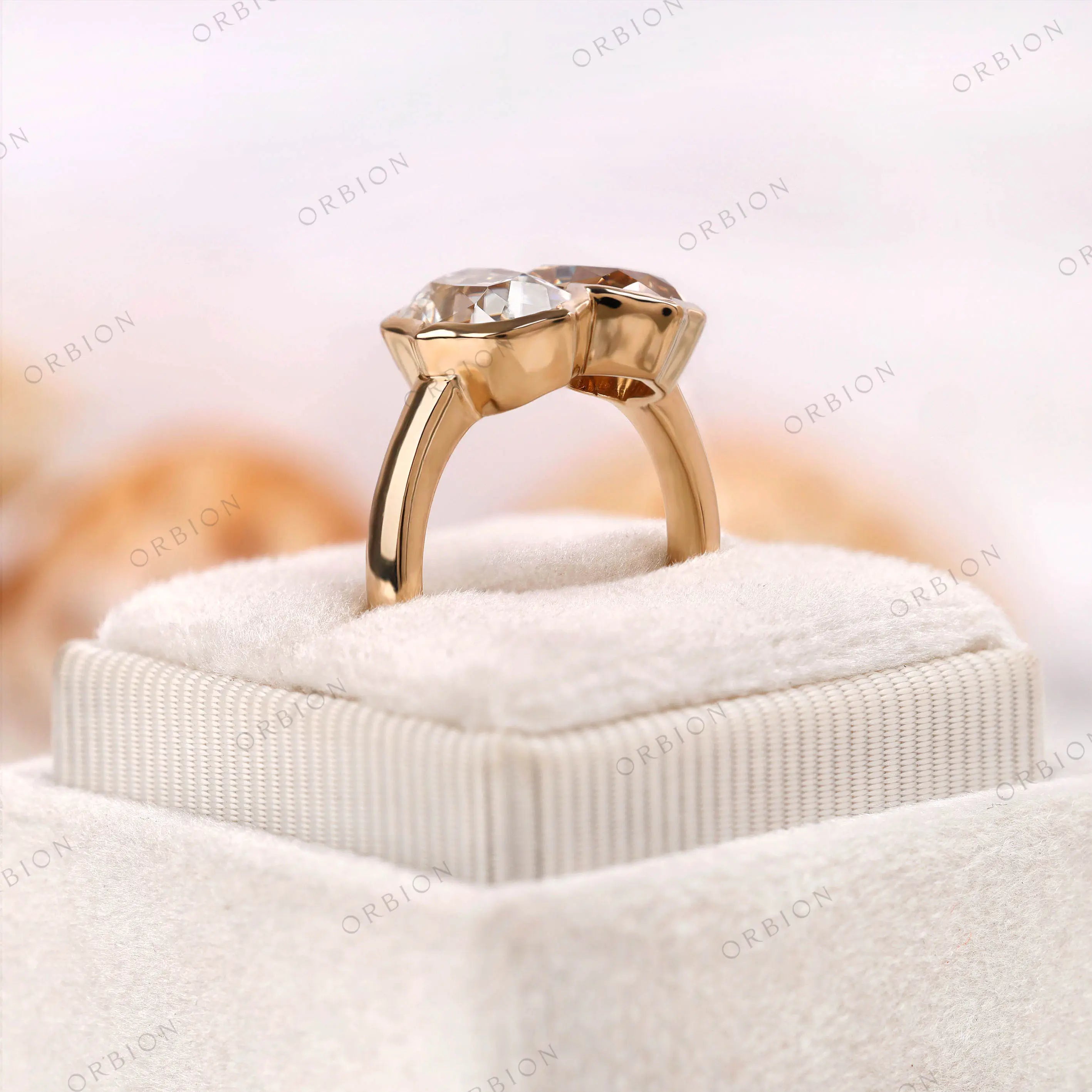 Elevated display view of bezel set Toi et Moi ring in yellow gold