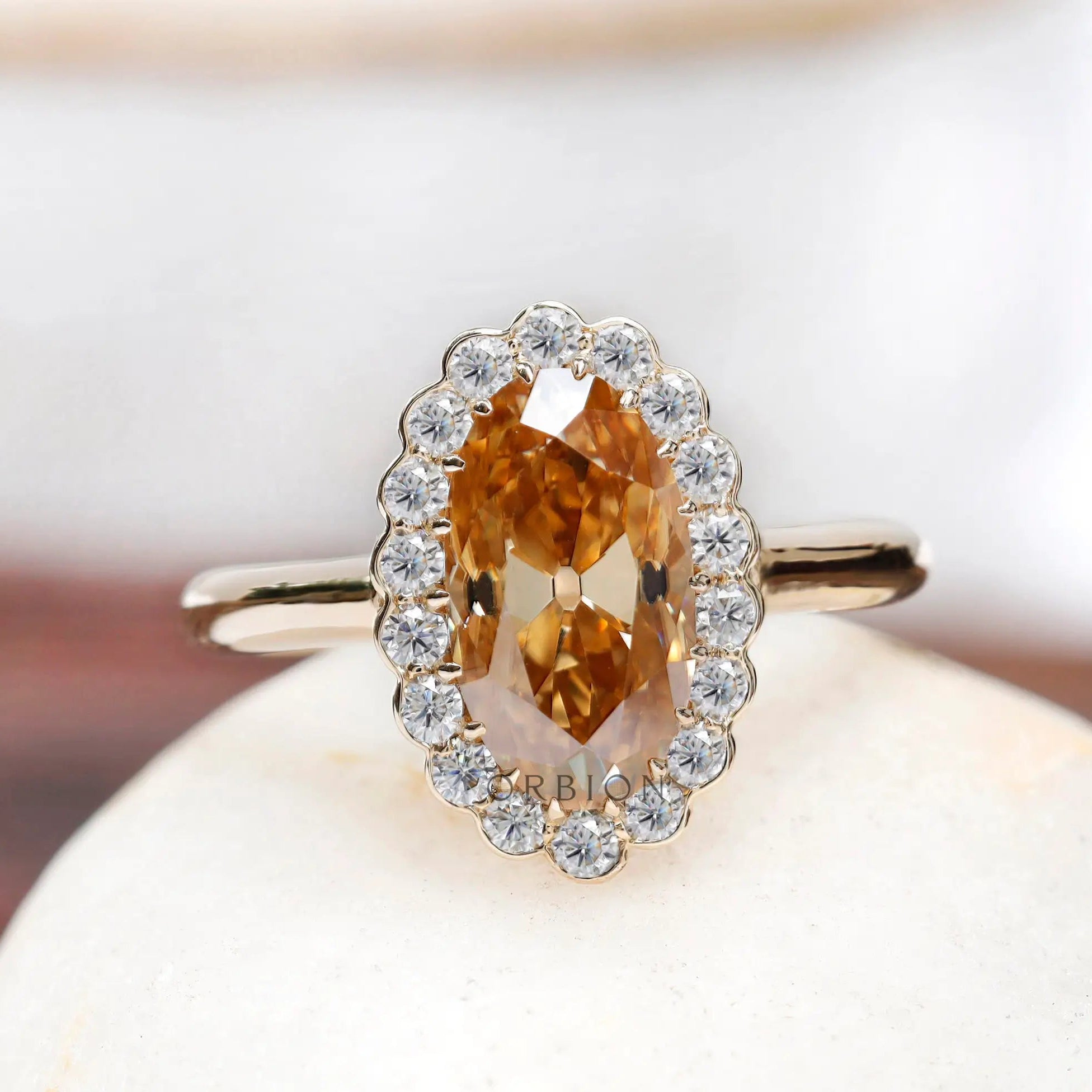 Oval old mine cut dark champagne moissanite halo ring in 10K yellow gold, front view