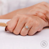 Round diamond engagement ring worn on hand in yellow gold
