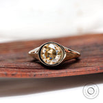 Light champagne round moissanite solitaire bezel signet ring top view
