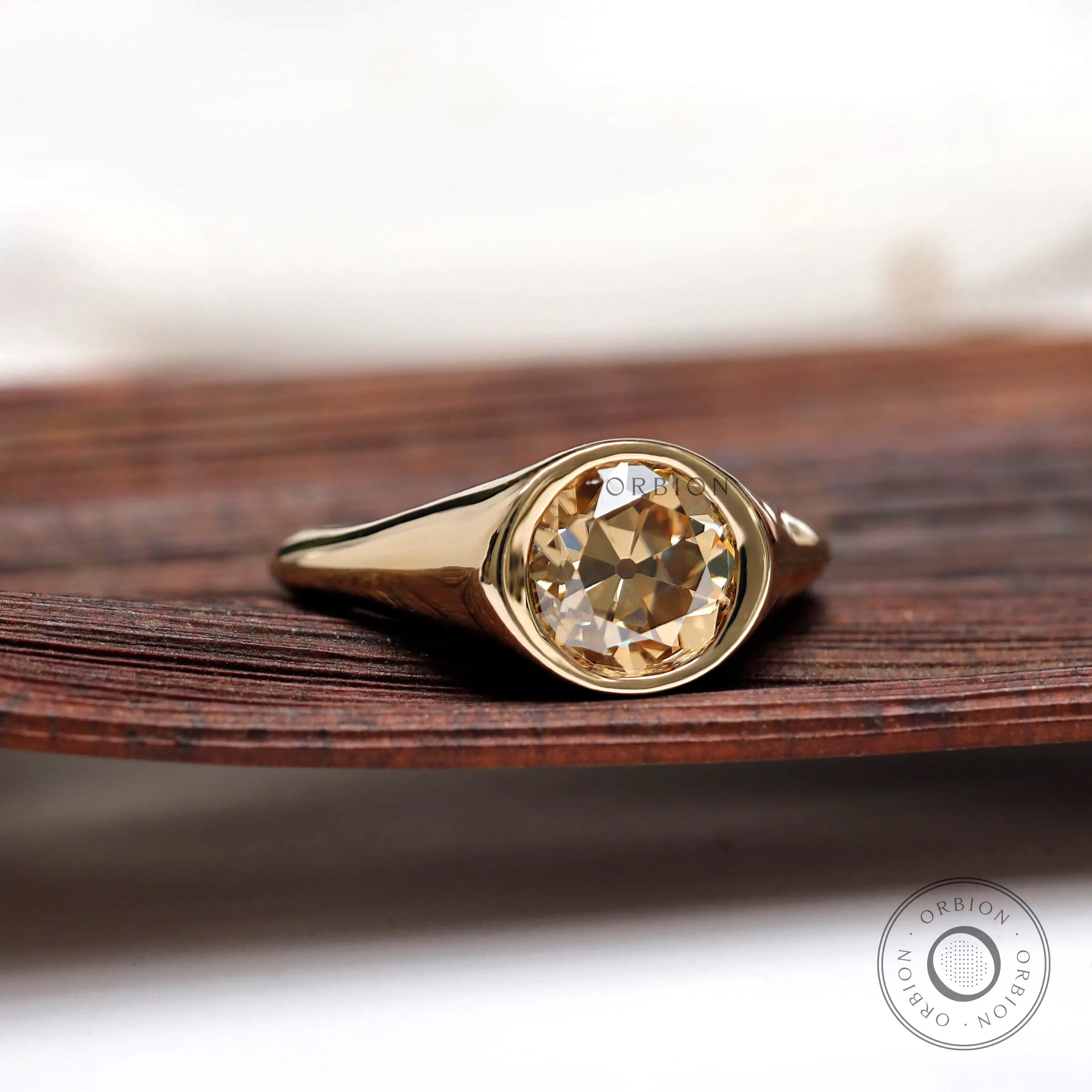 Old European cut moissanite solitaire signet ring front angle close-up