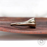 Side profile of bezel set solitaire moissanite signet ring in yellow gold