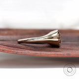 Side profile of bezel set solitaire moissanite signet ring in yellow gold