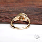 Underside view of solitaire signet ring with champagne moissanite