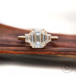 Emerald cut moissanite three stone ring front view