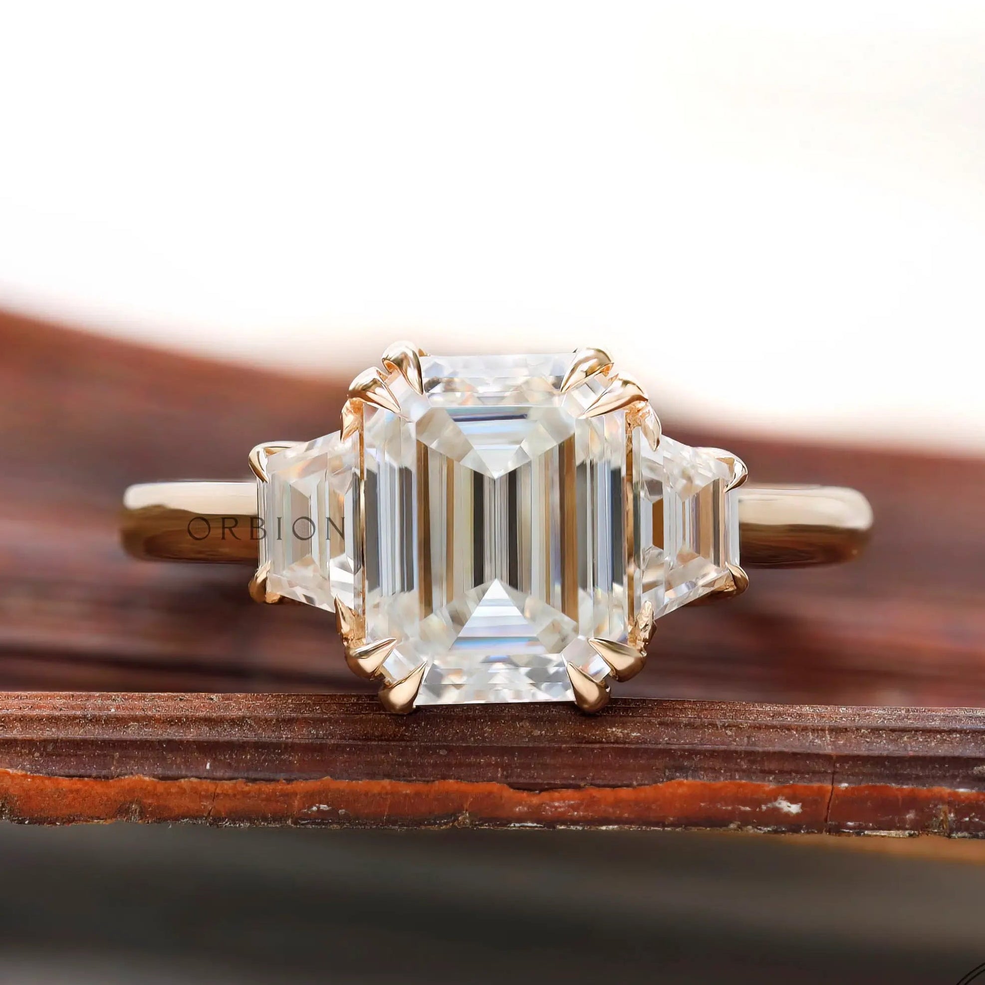 Emerald cut moissanite three stone ring front view