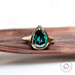 Pear dark green moissanite bezel solitaire signet ring in yellow gold