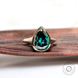 Pear dark green moissanite bezel solitaire signet ring in yellow gold