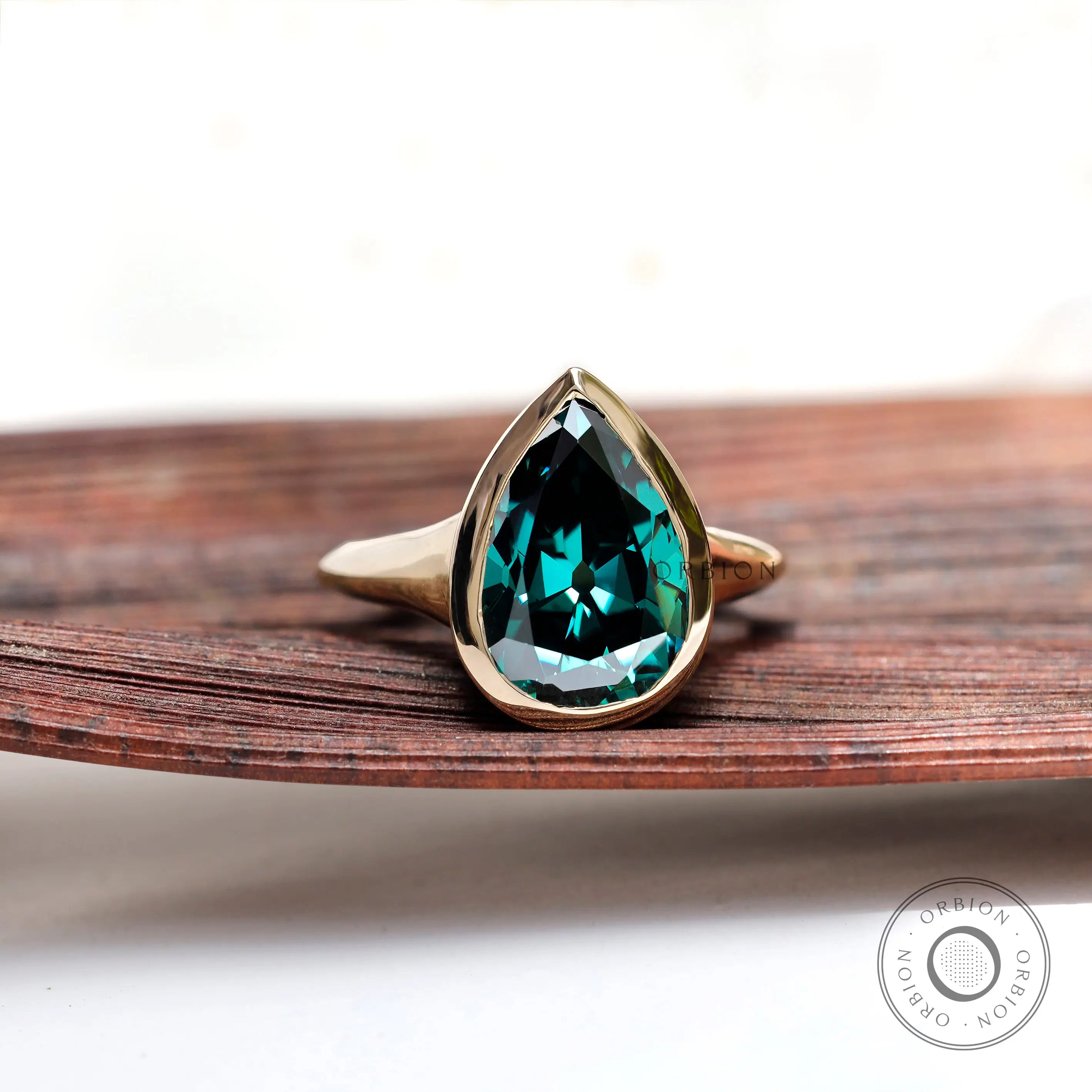 Pear dark green moissanite bezel solitaire signet ring in yellow gold