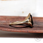 Side profile of pear dark green moissanite bezel solitaire signet ring