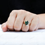 Pear dark green moissanite bezel signet ring worn on hand