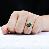 Pear dark green moissanite bezel signet ring worn on hand
