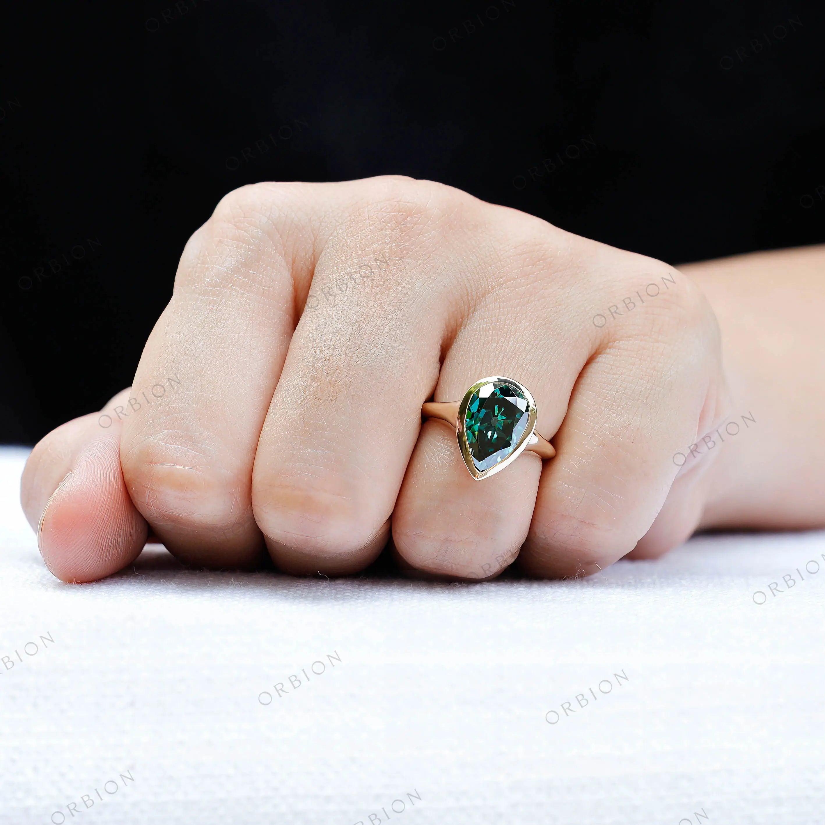 Pear dark green moissanite bezel signet ring worn on hand