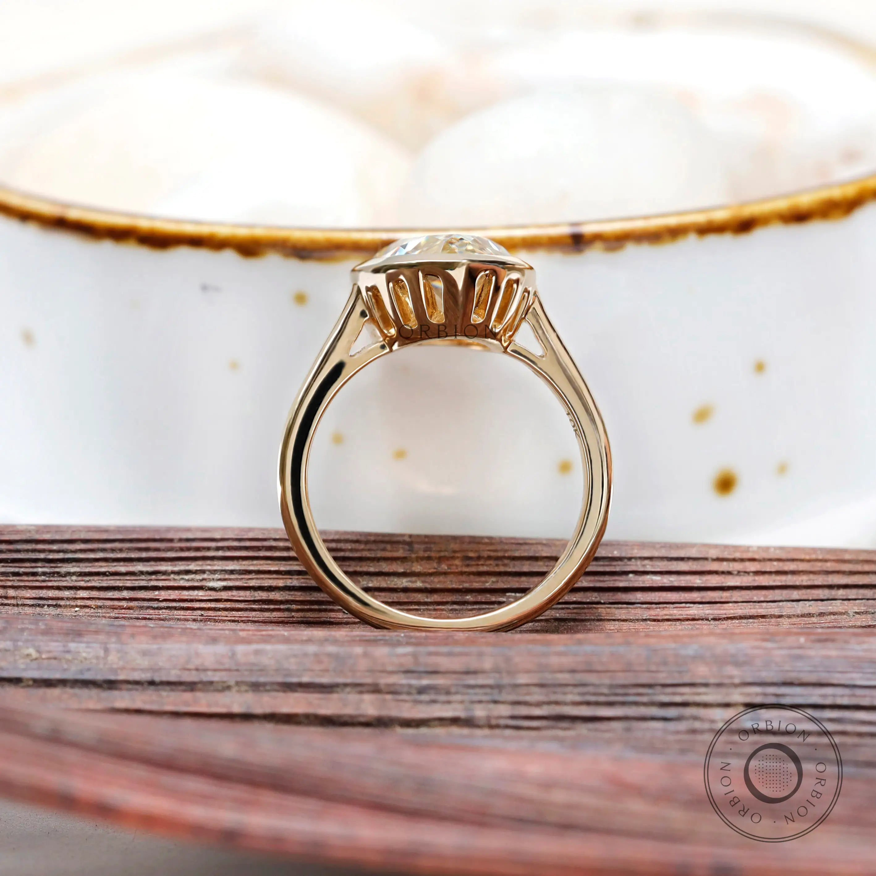 Pear bezel solitaire ring lifestyle image with natural lighting