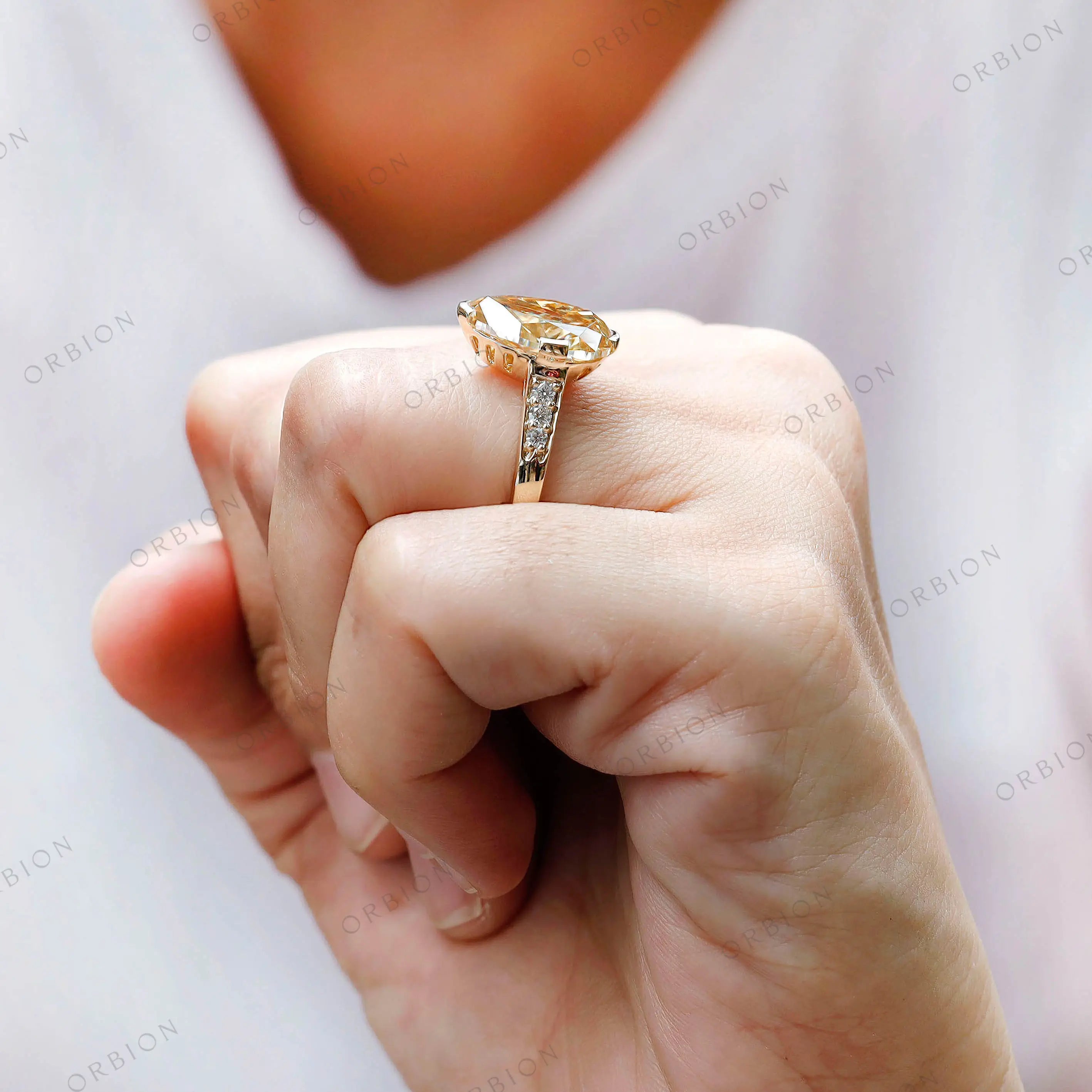Hand worn pear moissanite ring side perspective