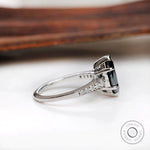 Side profile of deep green marquise moissanite ring with tapered white gold band