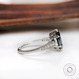Side profile of deep green marquise moissanite ring with tapered white gold band