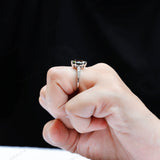 Deep green marquise moissanite ring worn on hand side angle