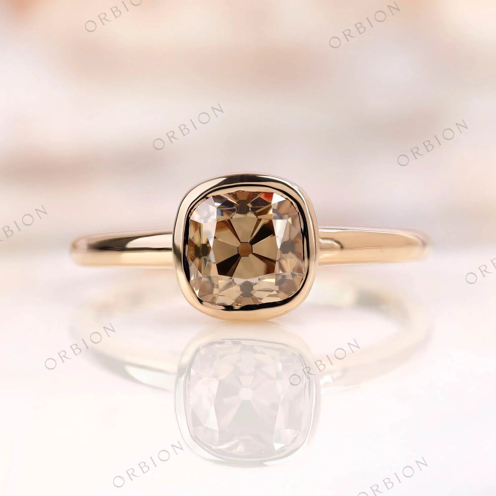 Moissanite Light Champagne Old Mine Cut bezel set solitaire ring with 10K yellow gold band
