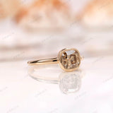 Close-up of Moissanite Light Champagne Old Mine Cut bezel set solitaire ring in 10K yellow gold
