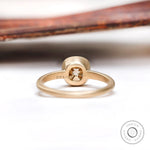 Back view of the solitaire cushion cut dark champagne moissanite bezel set engagement ring in matte