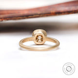 Back view of the solitaire cushion cut dark champagne moissanite bezel set engagement ring in matte