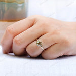 Moissanite Light Champagne Old Mine Cut bezel set solitaire ring with 10K yellow gold band worn on hand