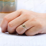 Moissanite Light Champagne Old Mine Cut bezel set solitaire ring with 10K yellow gold band worn on hand