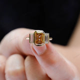 Modern vintage bezel set three stone ring in yellow gold close up