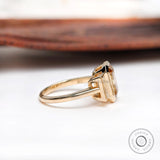 Three stone engagement ring with dark champagne center stone