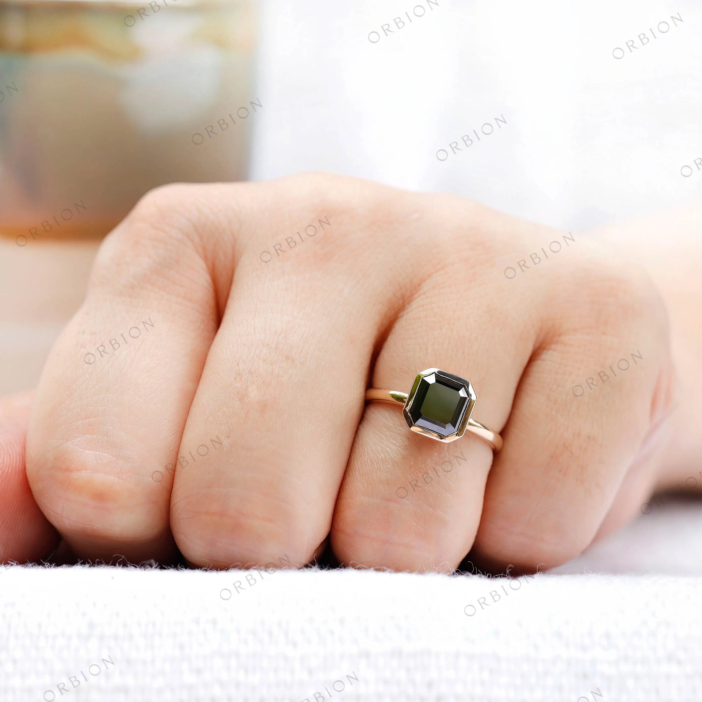 Minimalist moissanite ring worn on hand