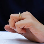 Deep green emerald cut moissanite ring close up view