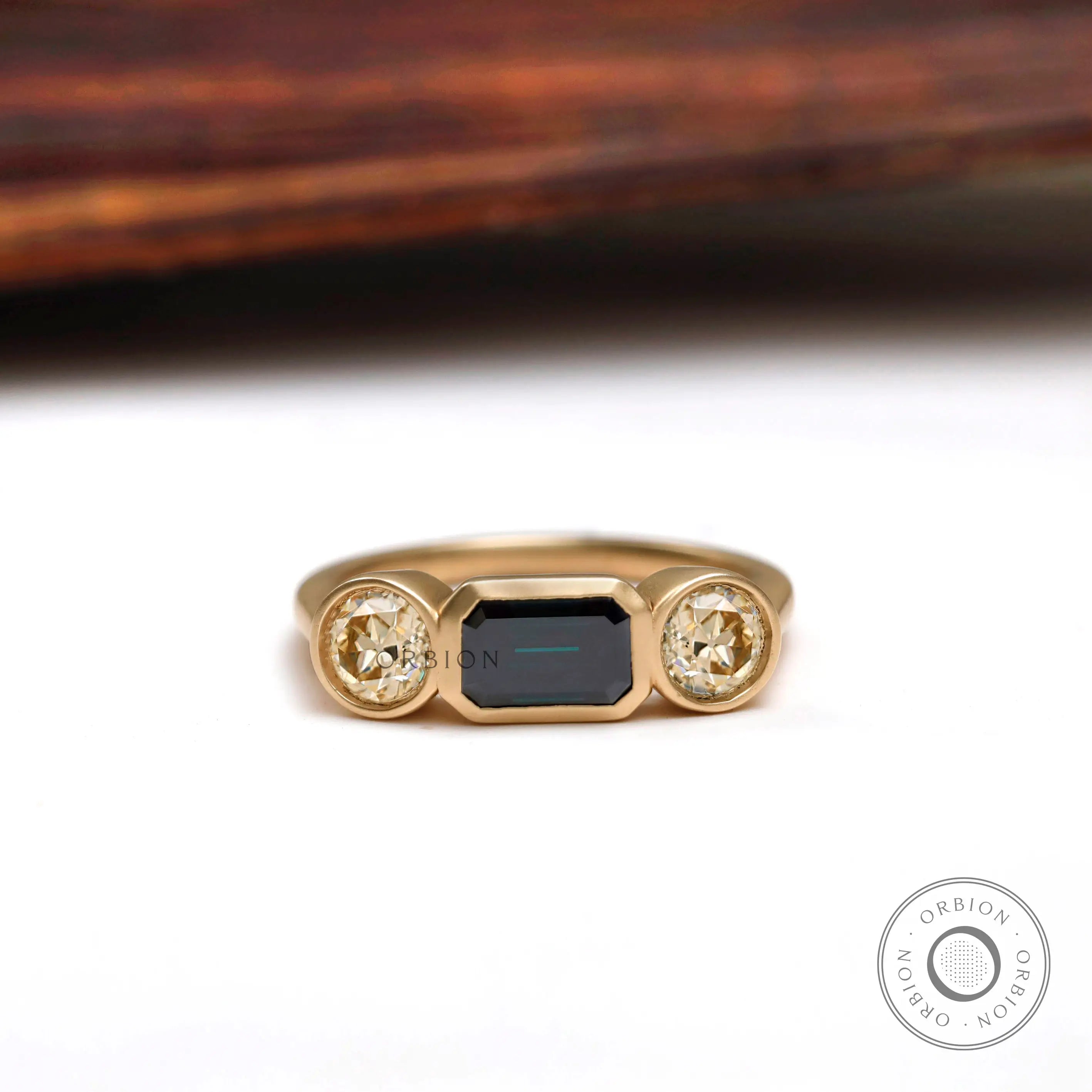 East west emerald cut green moissanite trilogy engagement ring in 14K yellow gold