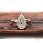 Pear moissanite solitaire ring old mine cut in yellow gold front view