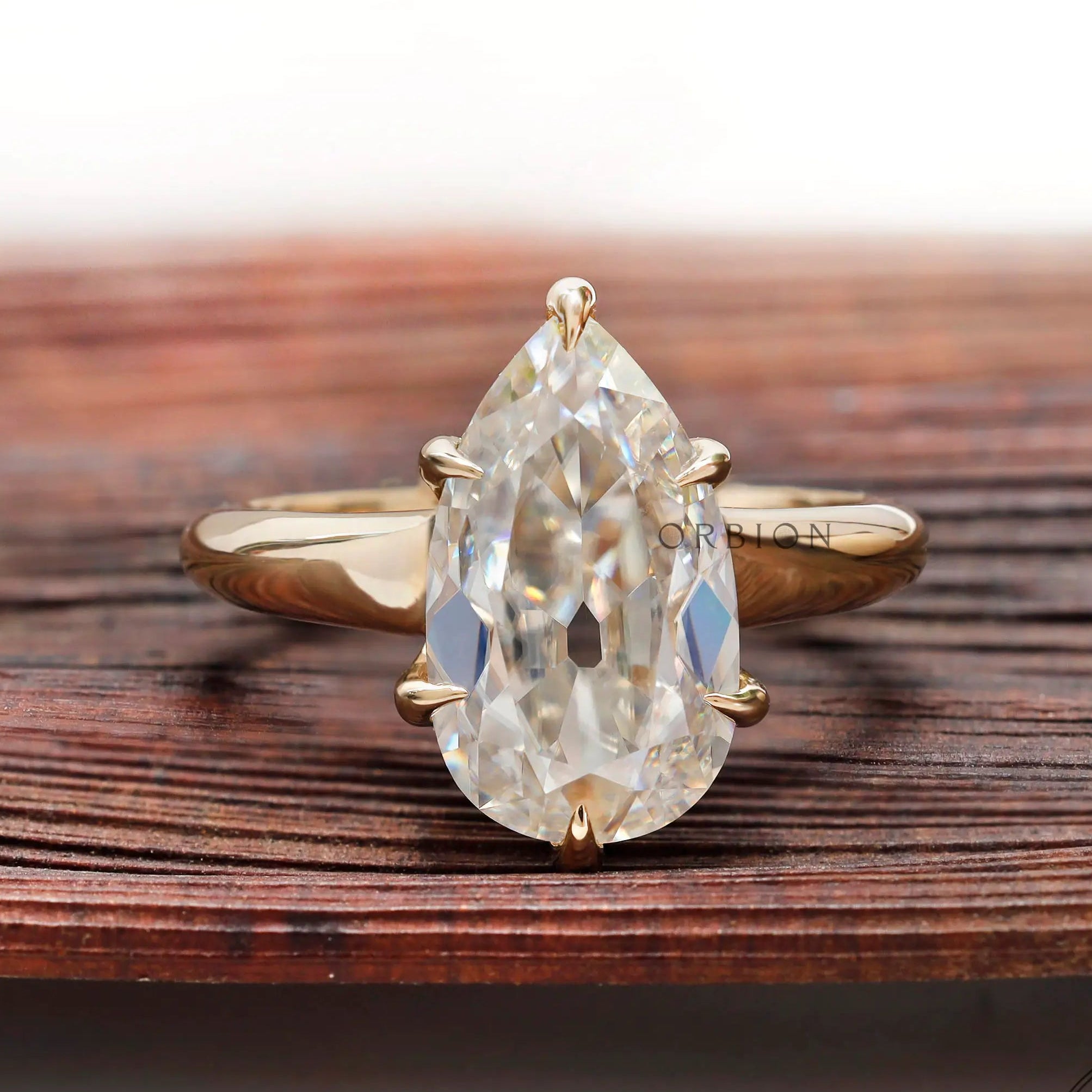 Pear moissanite solitaire ring old mine cut in yellow gold front view