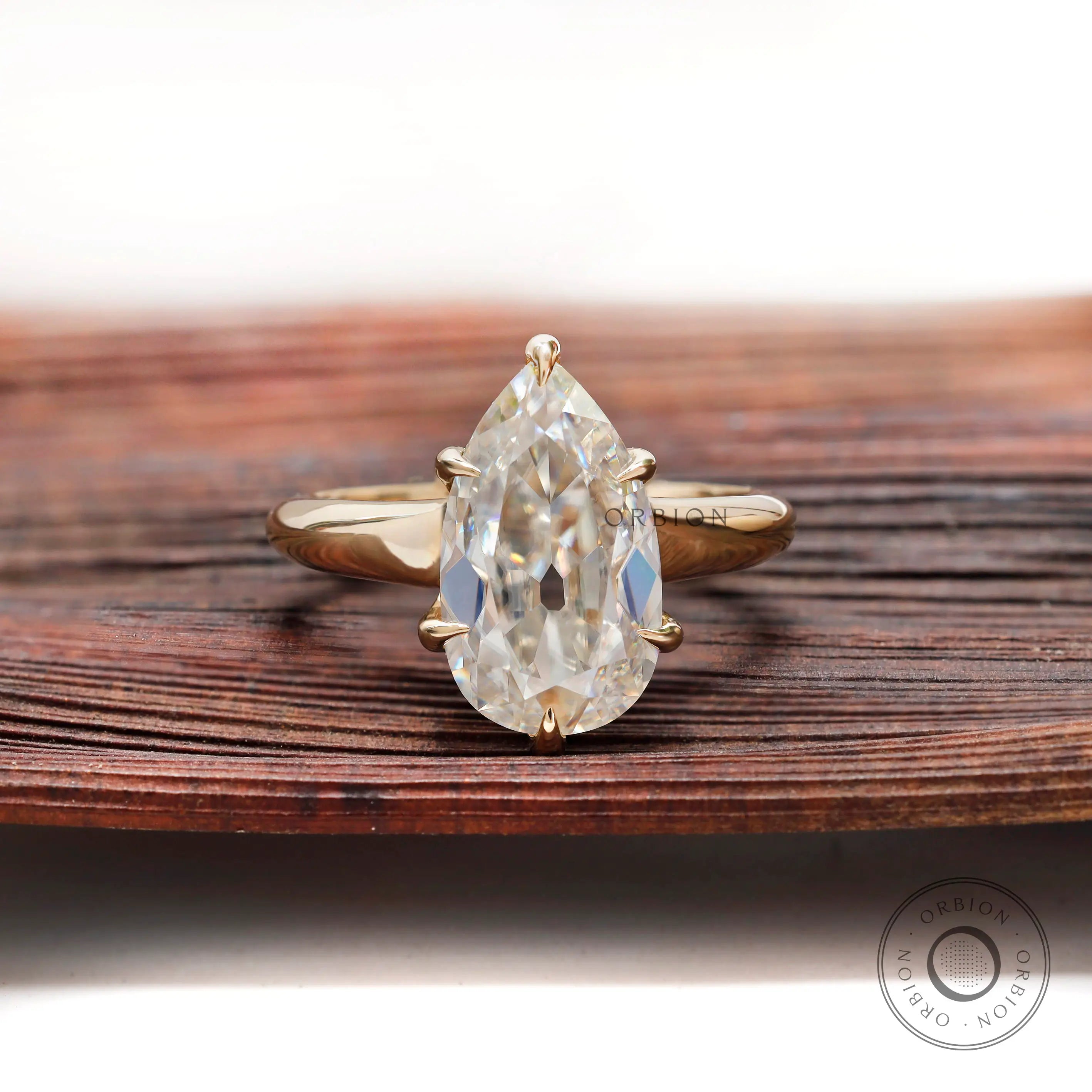 Pear moissanite solitaire ring old mine cut in yellow gold front view
